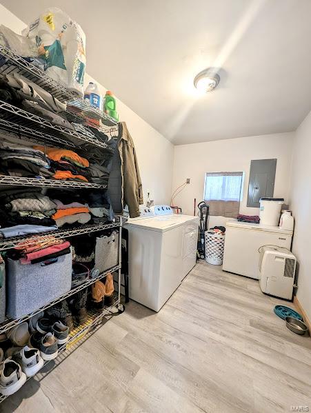 laundry area with independent washer and dryer and light hardwood / wood-style floors