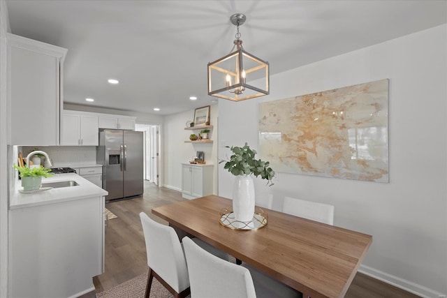 dining room with sink and dark hardwood / wood-style floors