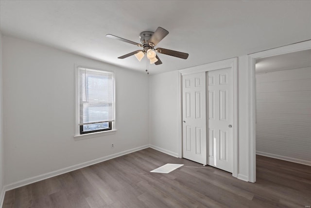 unfurnished bedroom featuring hardwood / wood-style flooring, ceiling fan, and a closet