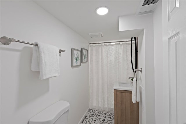 bathroom featuring vanity, a shower with shower curtain, tile patterned floors, and toilet