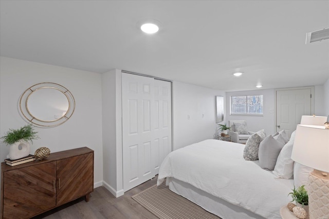 bedroom featuring light hardwood / wood-style flooring and a closet