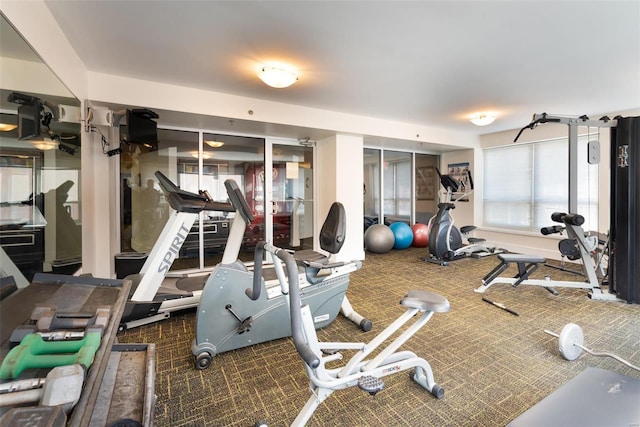 gym featuring dark carpet