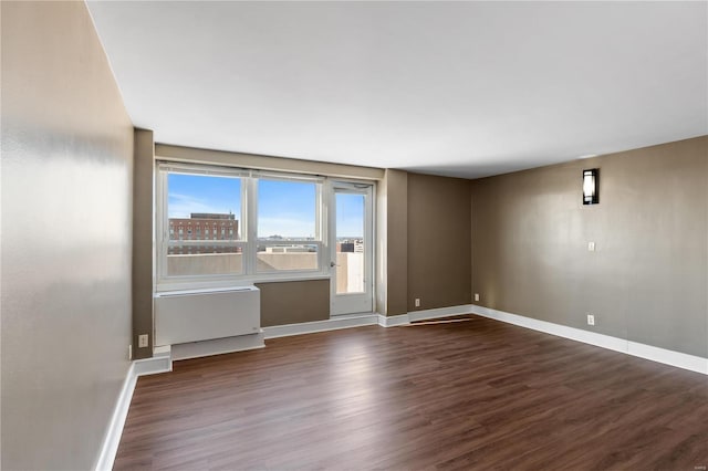 spare room with dark hardwood / wood-style floors