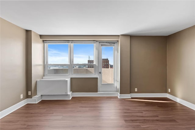 empty room with hardwood / wood-style floors