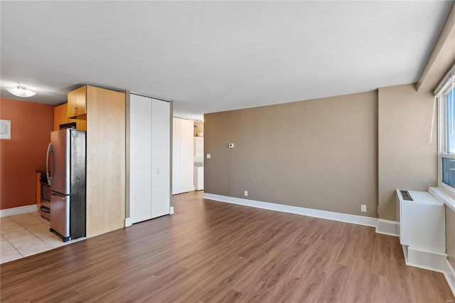 unfurnished living room with light hardwood / wood-style floors