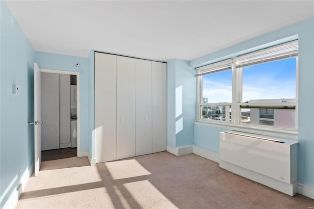 unfurnished bedroom featuring light carpet