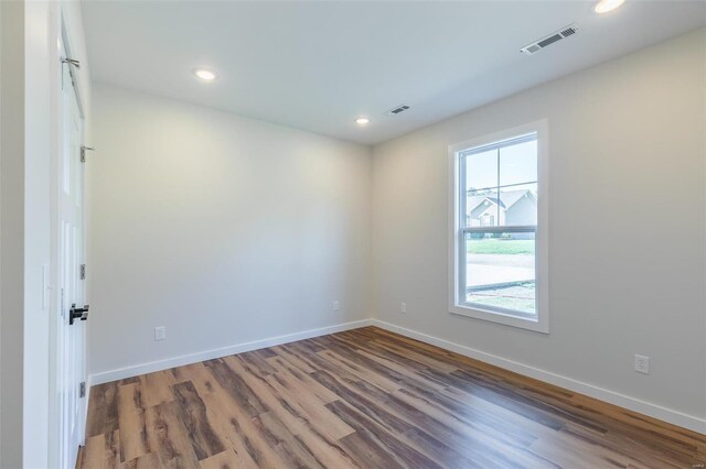 unfurnished room featuring hardwood / wood-style flooring