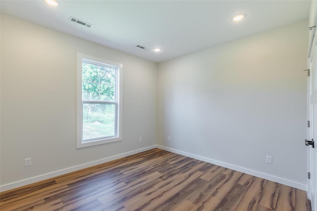 unfurnished room featuring hardwood / wood-style flooring