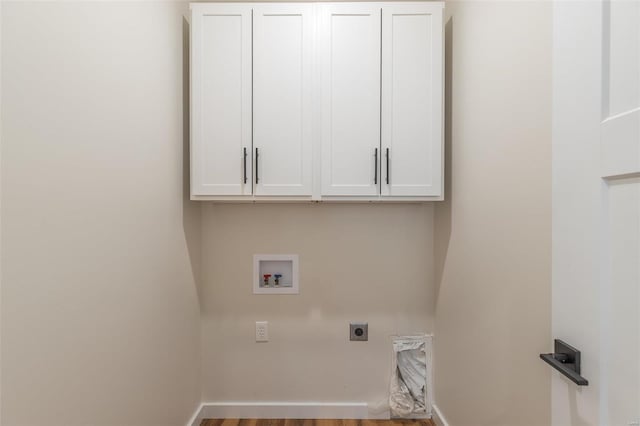 laundry area featuring hookup for a washing machine, hardwood / wood-style floors, electric dryer hookup, and cabinets