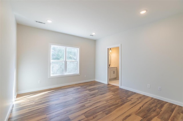 spare room featuring dark wood-type flooring