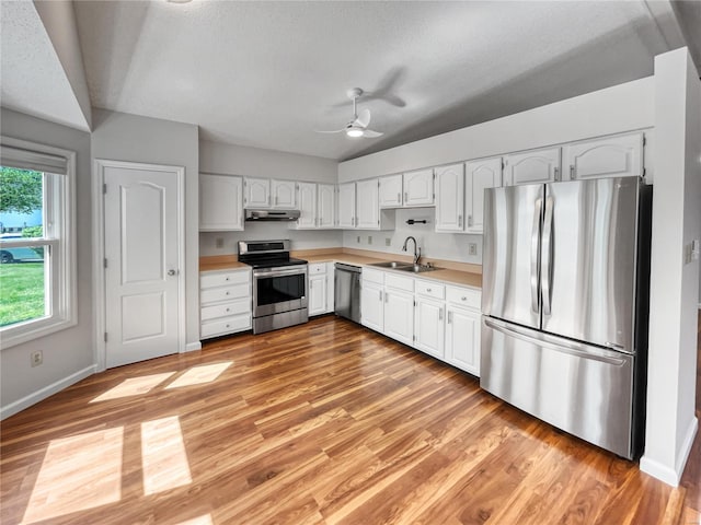 kitchen featuring appliances with stainless steel finishes, ceiling fan, light hardwood / wood-style floors, and white cabinets