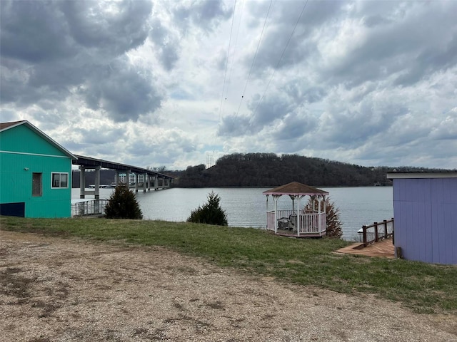 dock area featuring a water view and a yard