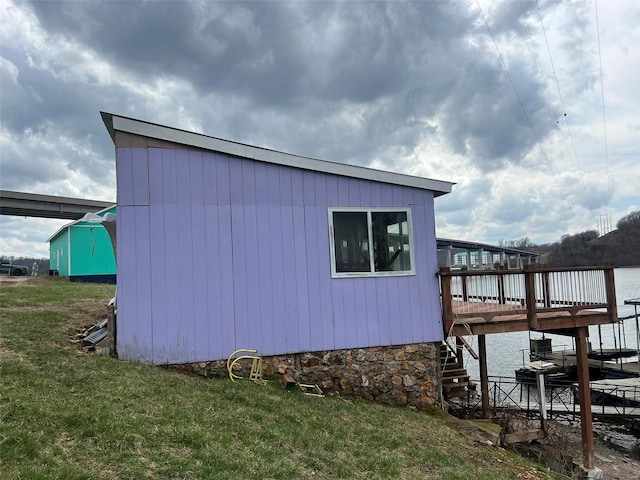 view of side of property with a deck and a yard