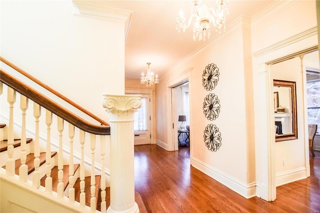 interior space with a chandelier, dark wood-type flooring, and crown molding