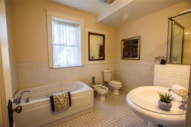 full bathroom featuring tile patterned floors, sink, tile walls, a bidet, and toilet