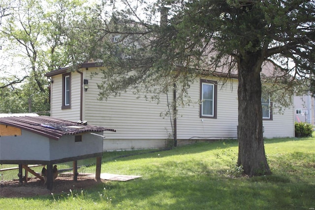 view of side of home featuring a yard