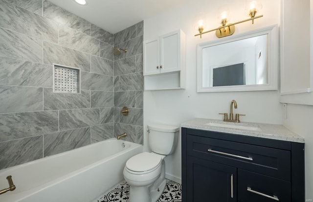 full bathroom featuring tile patterned flooring, tiled shower / bath combo, toilet, and vanity