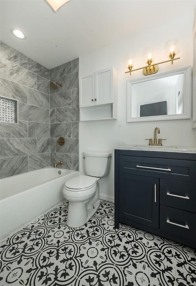 full bathroom featuring tile patterned floors, vanity, toilet, and tiled shower / bath