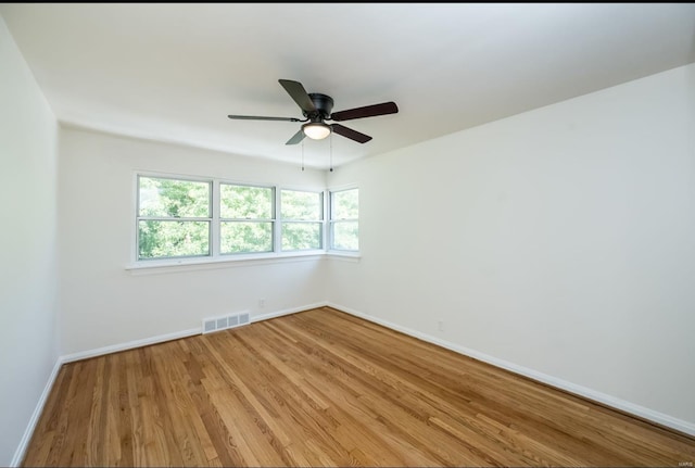 unfurnished room with ceiling fan and hardwood / wood-style floors