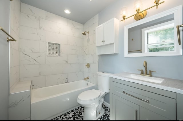 full bathroom featuring toilet, tile patterned floors, vanity, and tiled shower / bath combo