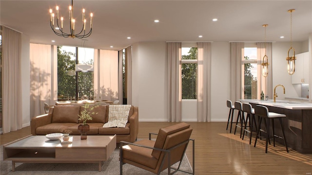 living room with wood-type flooring, a notable chandelier, and sink