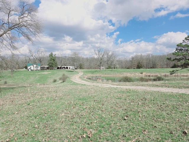 view of yard featuring a rural view and a water view