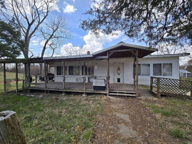 view of front of home with a front yard and a wooden deck