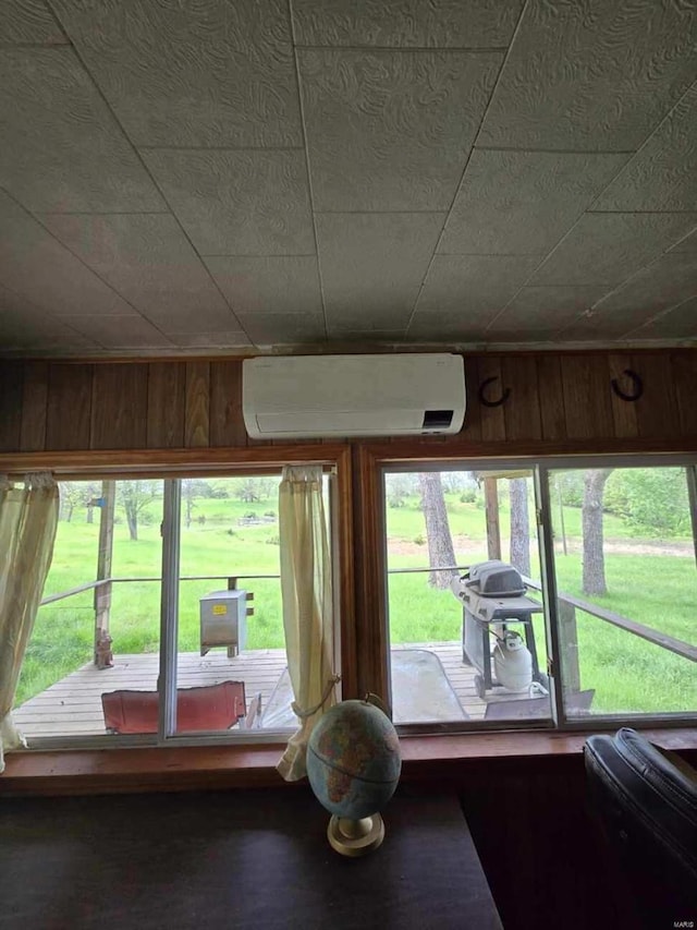 interior space featuring a wall unit AC and wooden walls