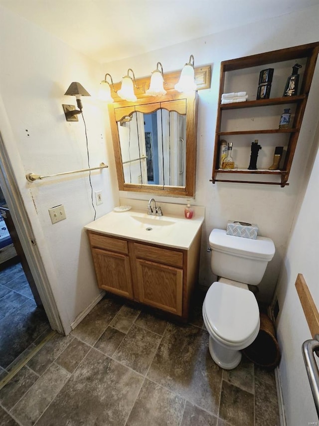 bathroom featuring vanity, tile floors, and toilet