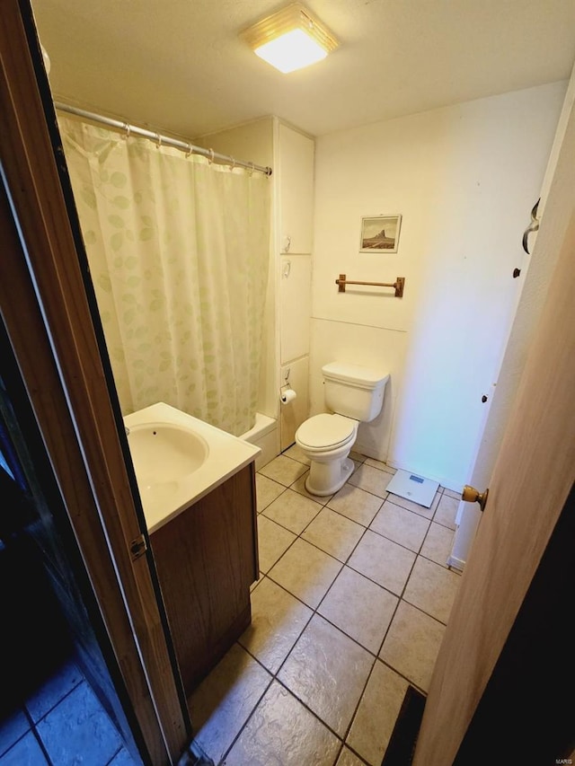 bathroom featuring vanity, tile floors, and toilet