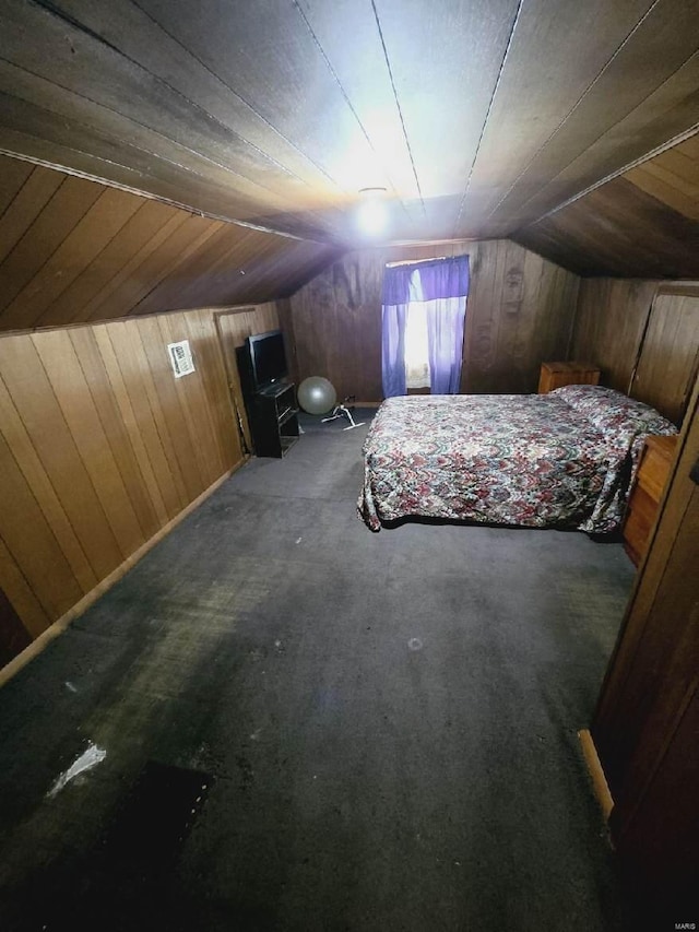 unfurnished bedroom with wood ceiling, wooden walls, and vaulted ceiling