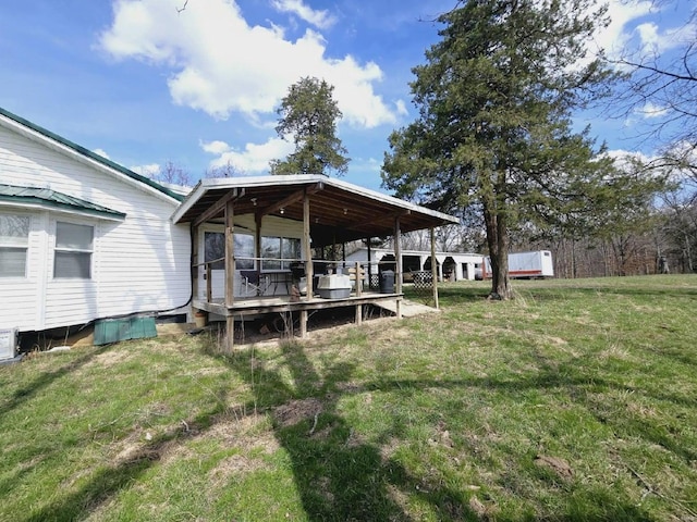 rear view of property with a wooden deck and a yard