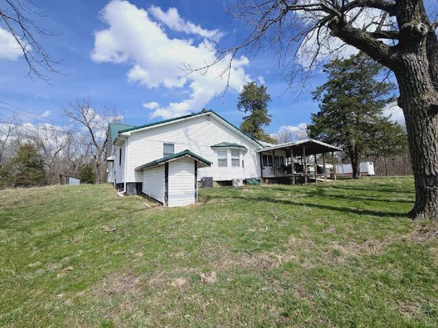 rear view of property featuring a lawn