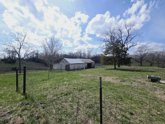 view of yard featuring an outdoor structure and a rural view