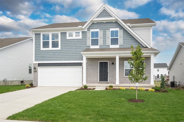 view of front of home featuring a front yard, central AC, and a garage