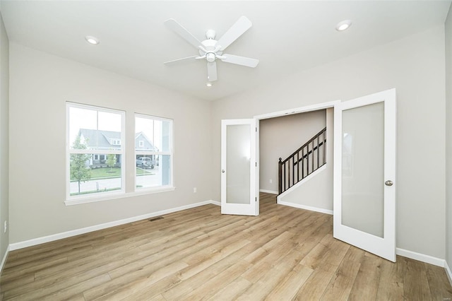 spare room featuring ceiling fan, light hardwood / wood-style floors, and french doors