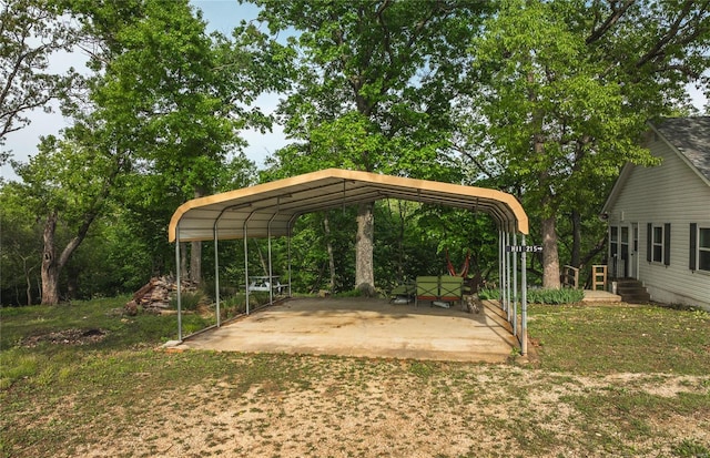 view of vehicle parking with a lawn and a carport