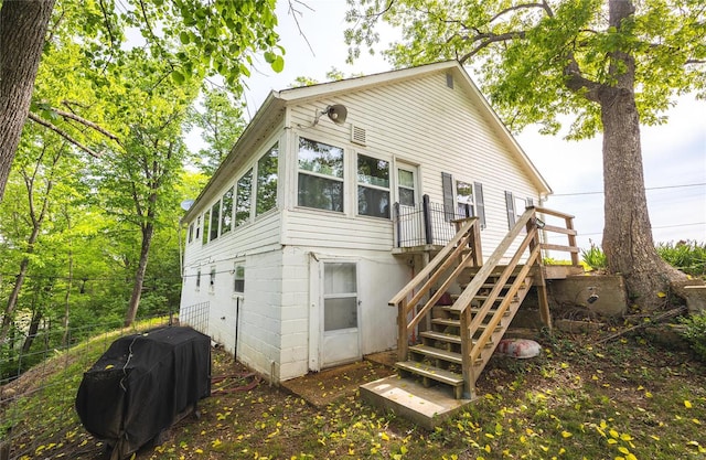 back of house featuring a wooden deck