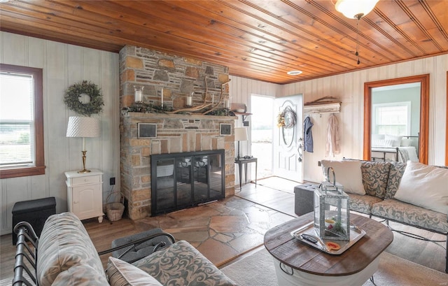 living room with wood ceiling, a fireplace, and a wealth of natural light