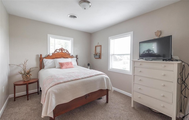 bedroom featuring light colored carpet