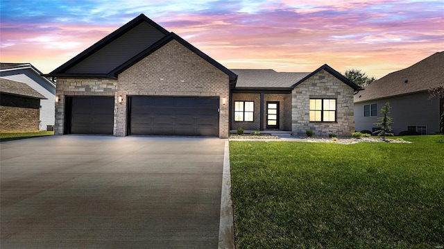 view of front of house with a yard and a garage