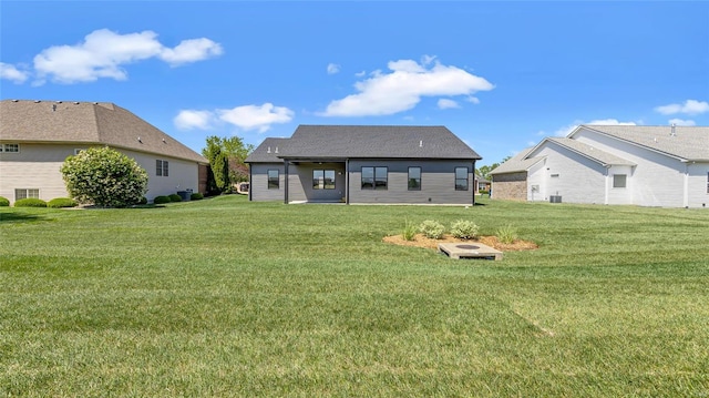 rear view of property with a yard