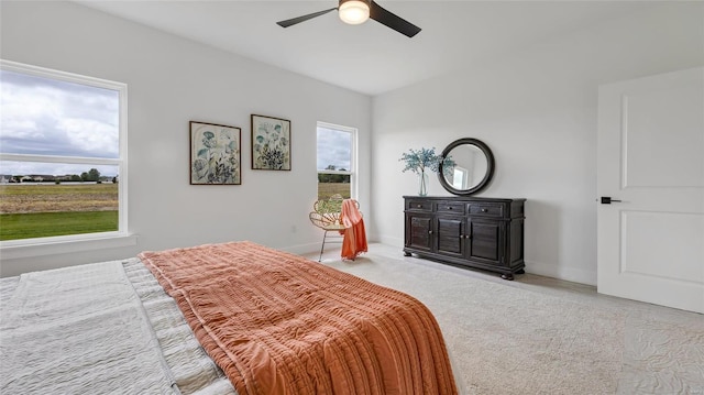 bedroom featuring ceiling fan and light carpet