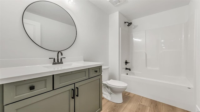 full bathroom with toilet, vanity, shower / bathtub combination, and hardwood / wood-style flooring