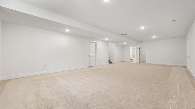 basement featuring light colored carpet