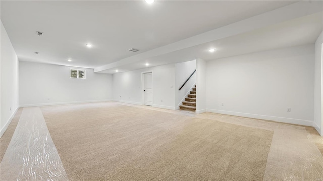 basement featuring light colored carpet