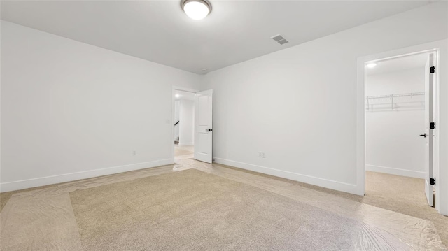 unfurnished room featuring light carpet