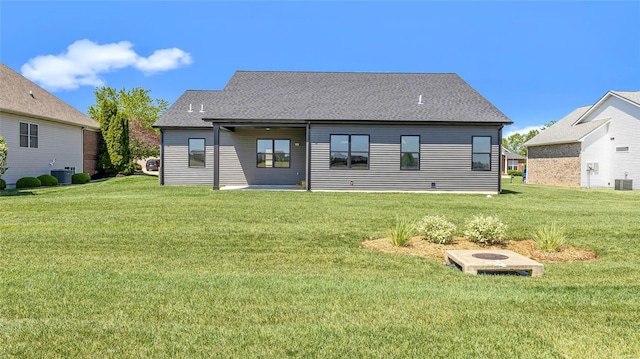 back of house featuring a lawn and central AC