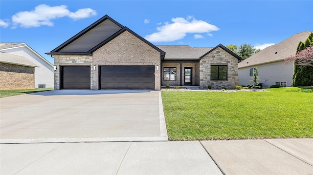 view of front of property with a garage and a front lawn