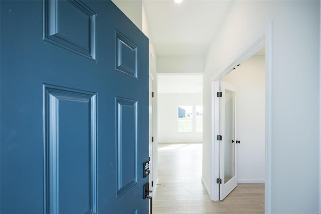 corridor with light hardwood / wood-style flooring